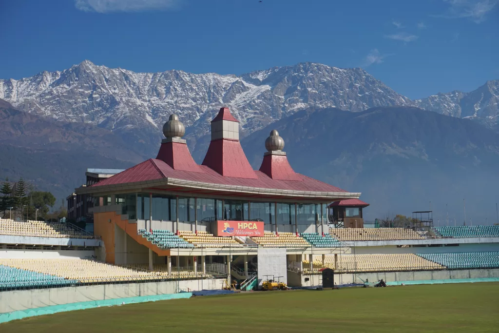 a stadium with a mountain in the background