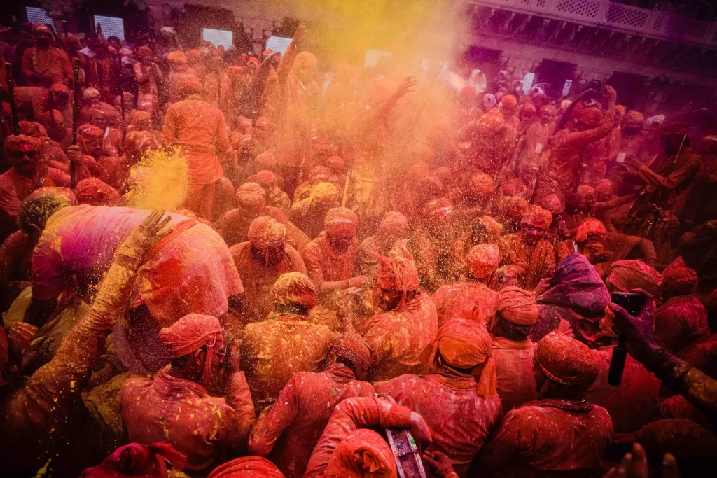 A group of people in red and yellow powder