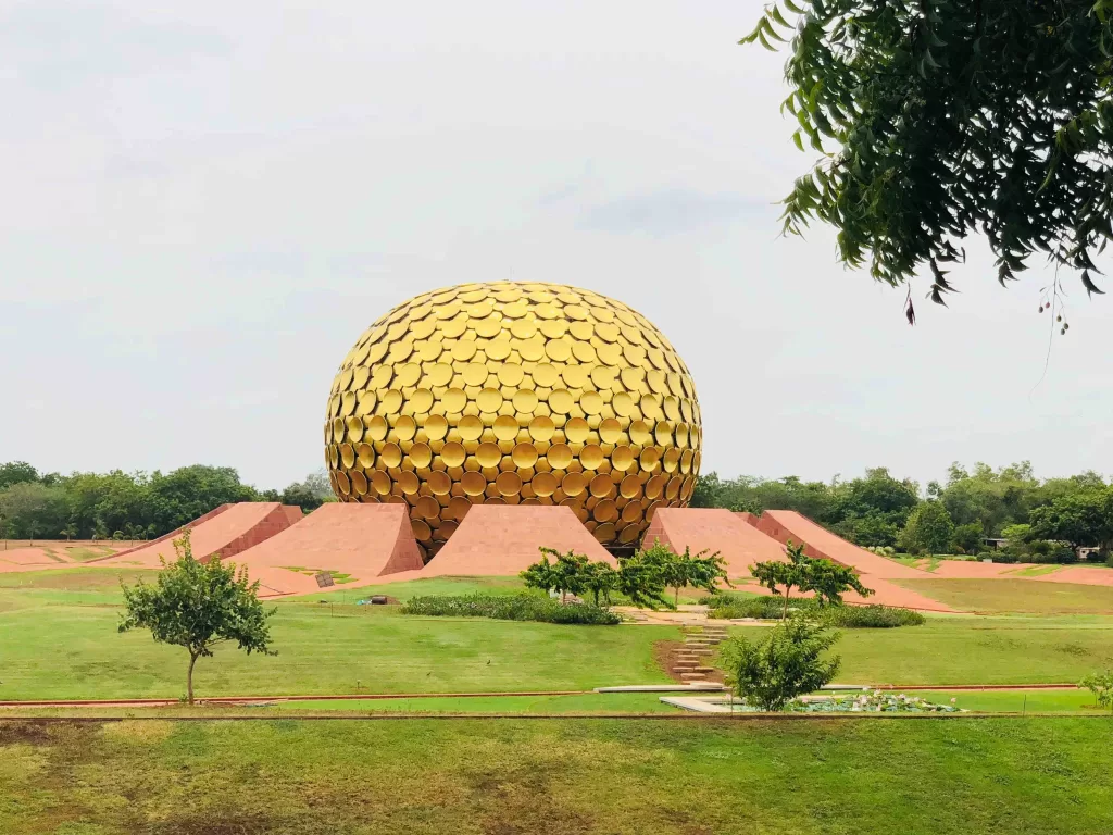 A large gold dome with a red brick structure in the middle