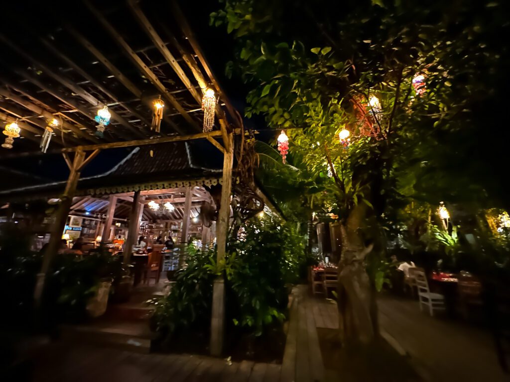 A restaurant lit up at night with lanterns