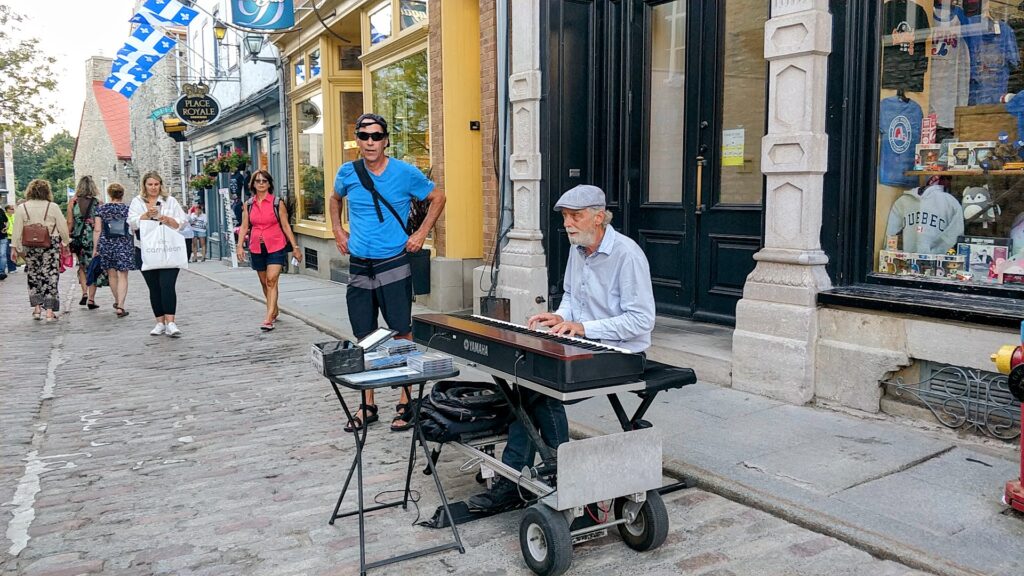 a person playing a piano on a street