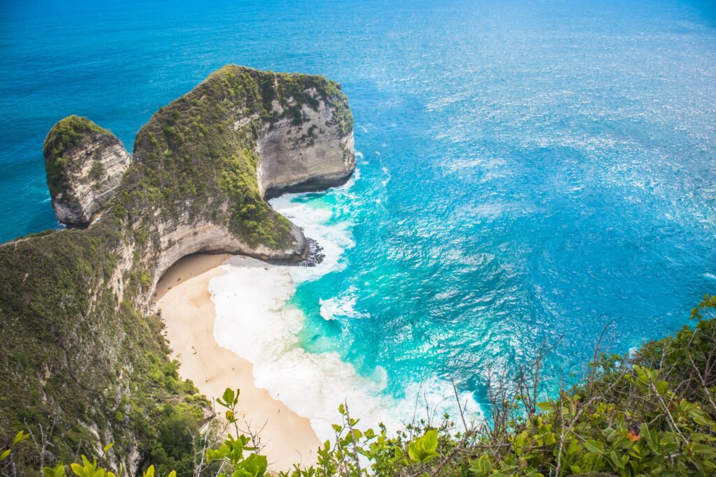 A beach with sand and water. A to-do on your Bali Itinerary.