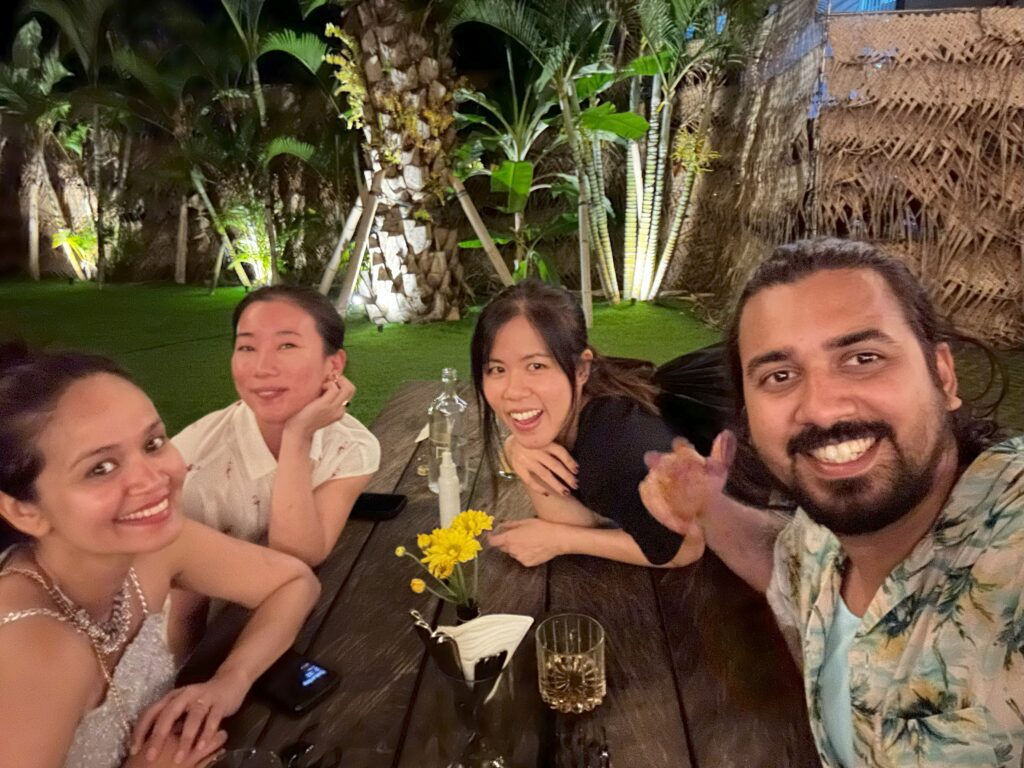 Group of people sitting on a table and smiling in a restaurant at Canggu Bali