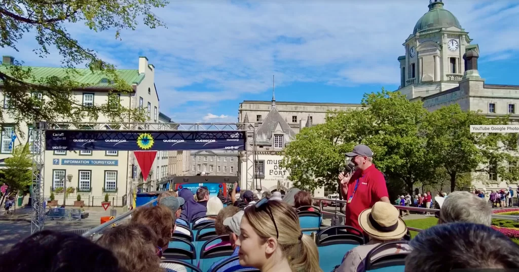 A bus tour guide with people sitting