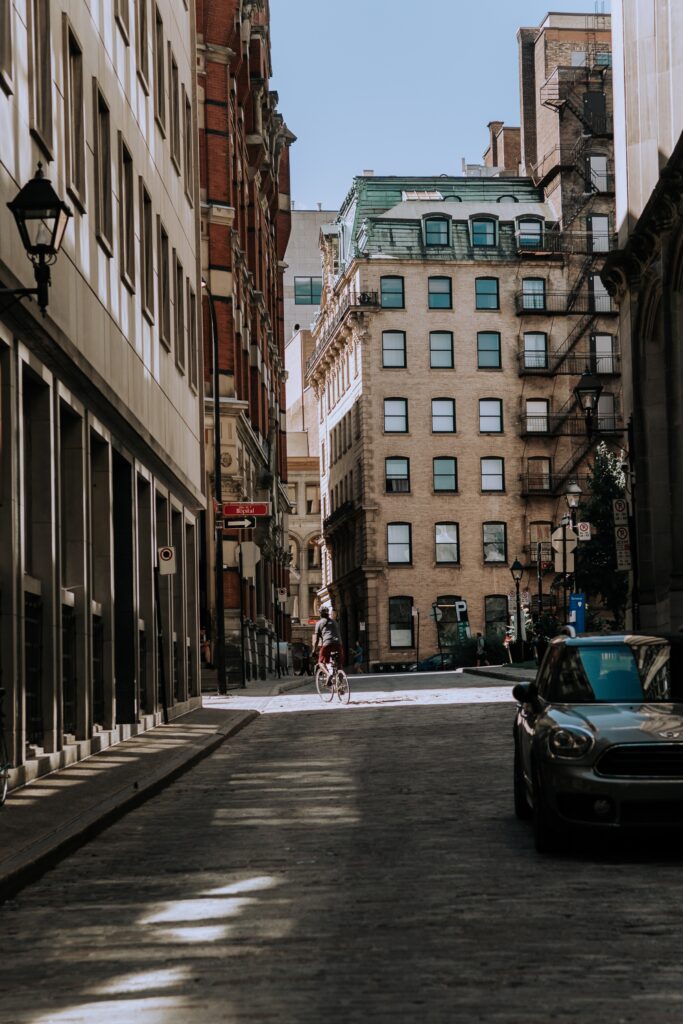 a person riding a bicycle on a street in a city