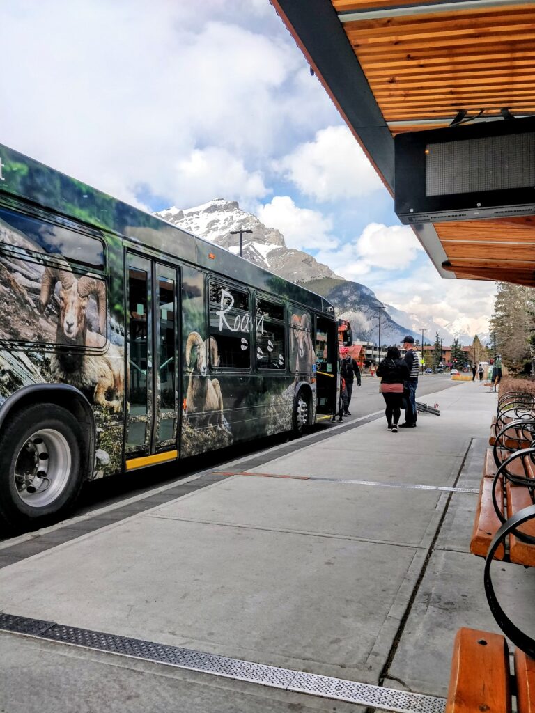 A bus parked at a bus stop. Public Transit in Banff