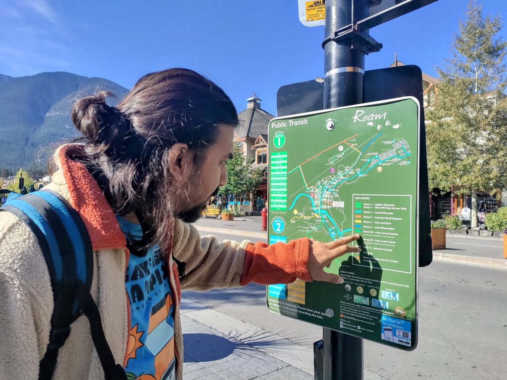 A person pointing at a map to use Pubic Transit in Banff