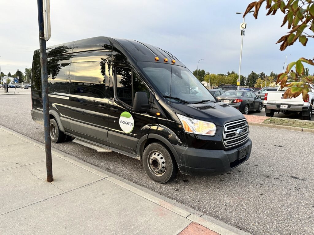 A black van parked on the side of a road