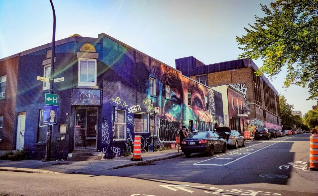 A building with graffiti on the side of the road