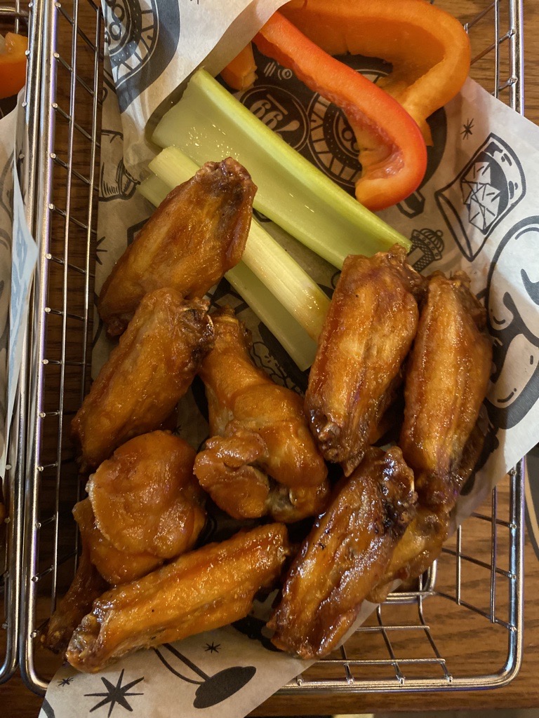 A basket of delicious hot wings on a table.