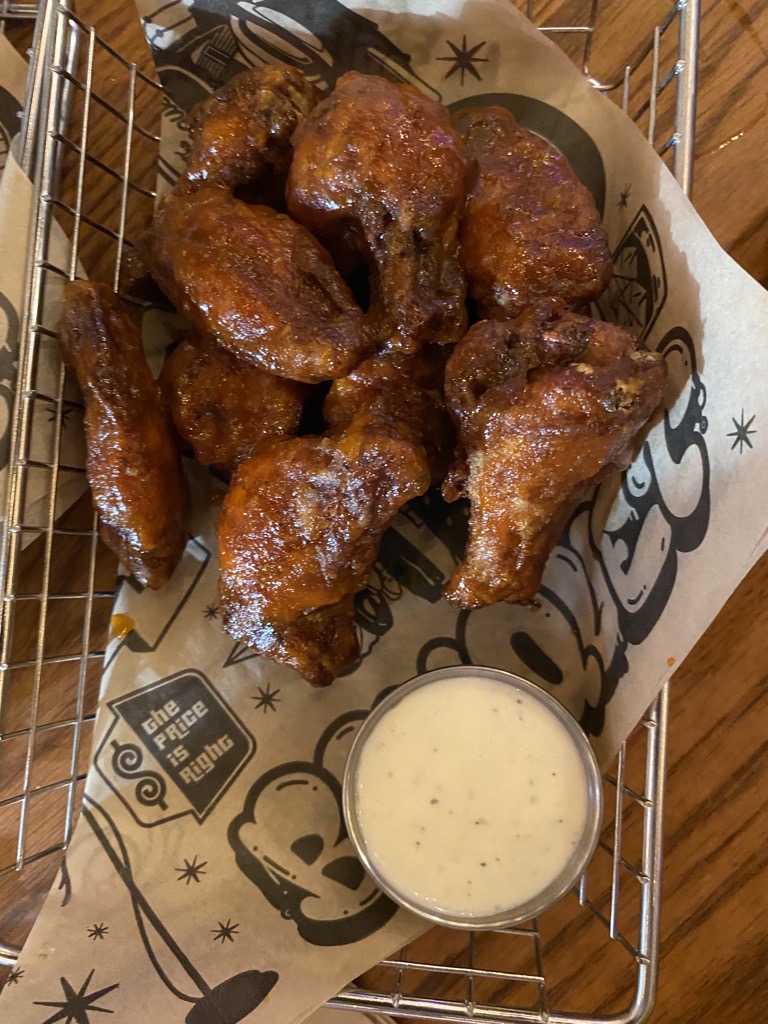 A basket of chicken wings and sauce