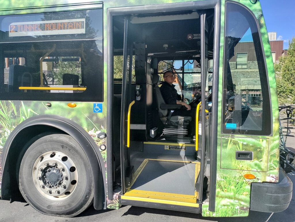 A bus with a person in the door