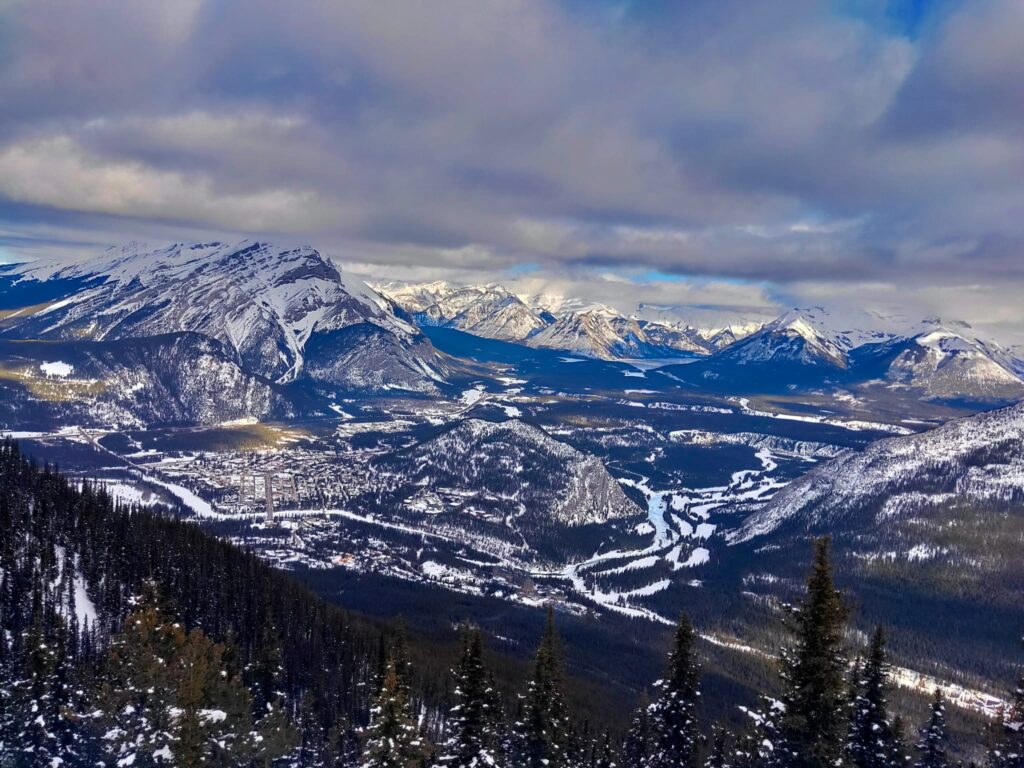 Valley with snow covered mountains and trees. A must see on your Ultimate Girls' Trip.