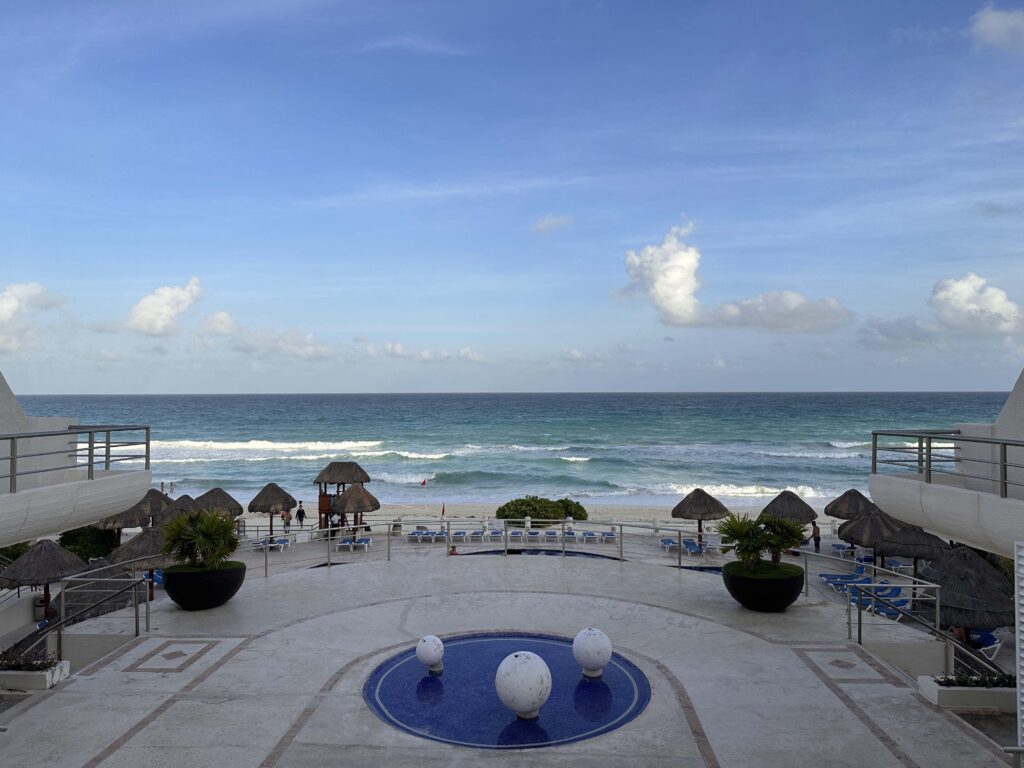 A beach with umbrellas and a pool