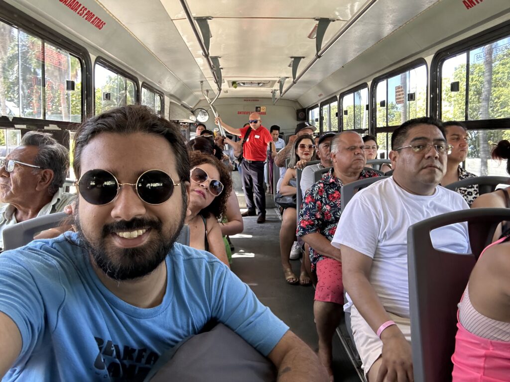 A group of people in bus stop. Fun to visit Cancun in public transit.