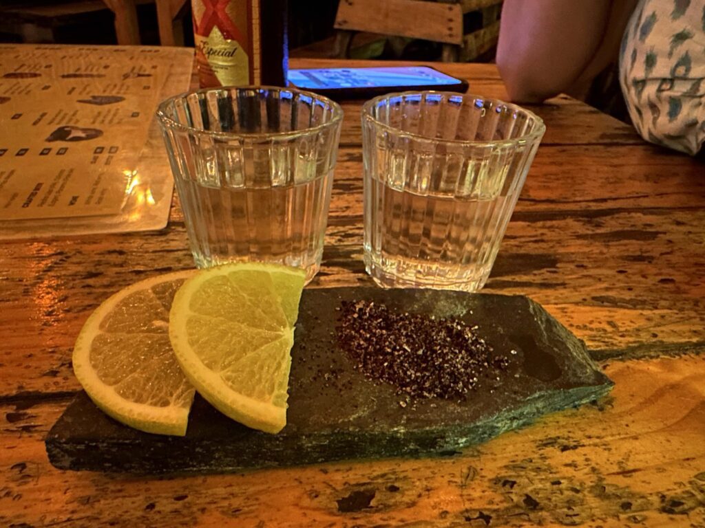 Two shot glasses with lime and salt