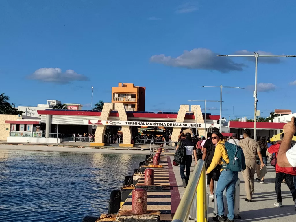 A port near a body of water with Isla Mujeres terminal written