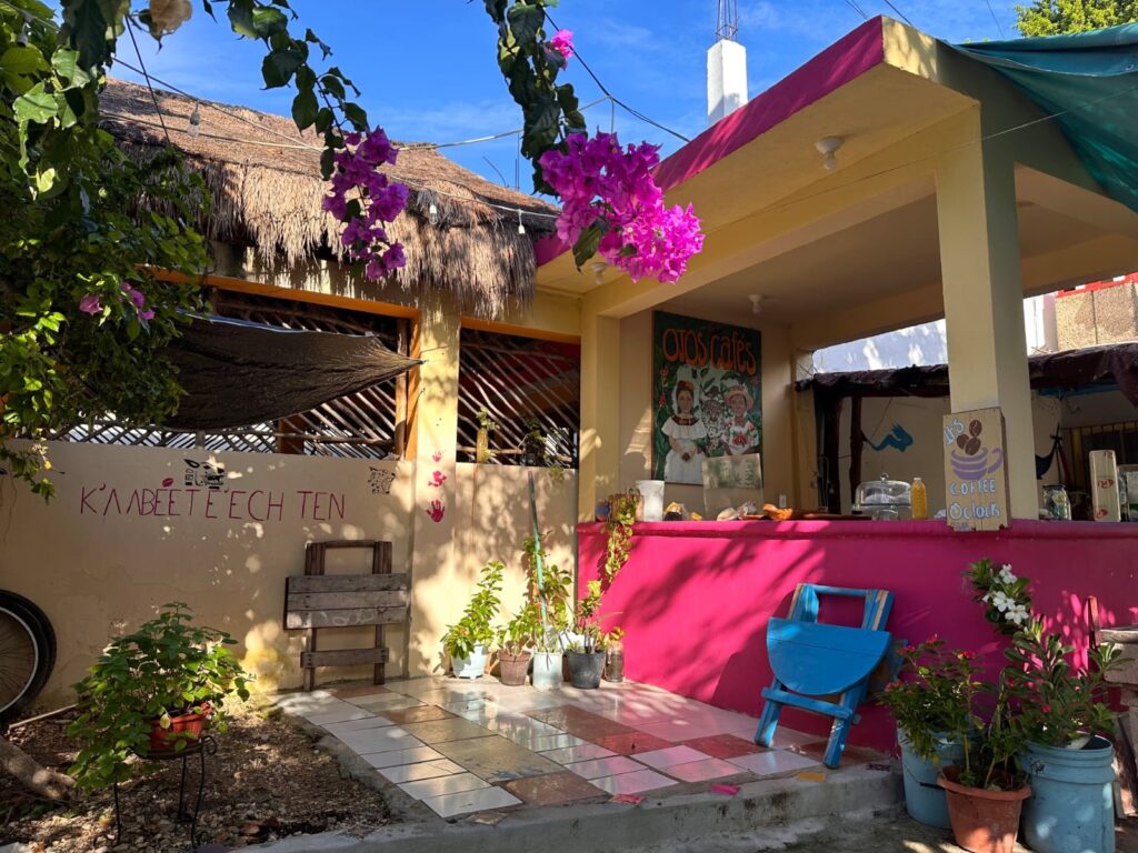 A building with a pink wall and a blue chair