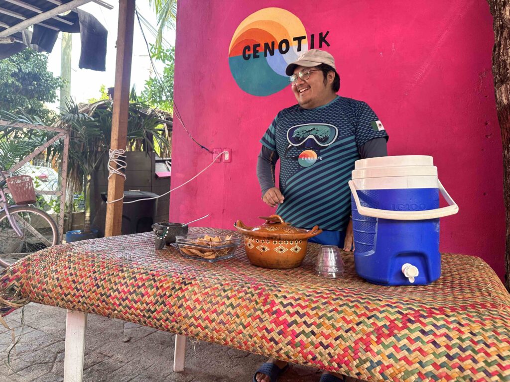 A person standing next to a table with food on it