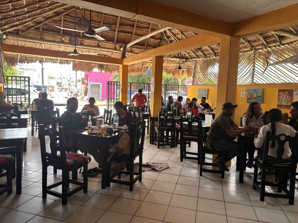 A group of people sitting at tables in a restaurant