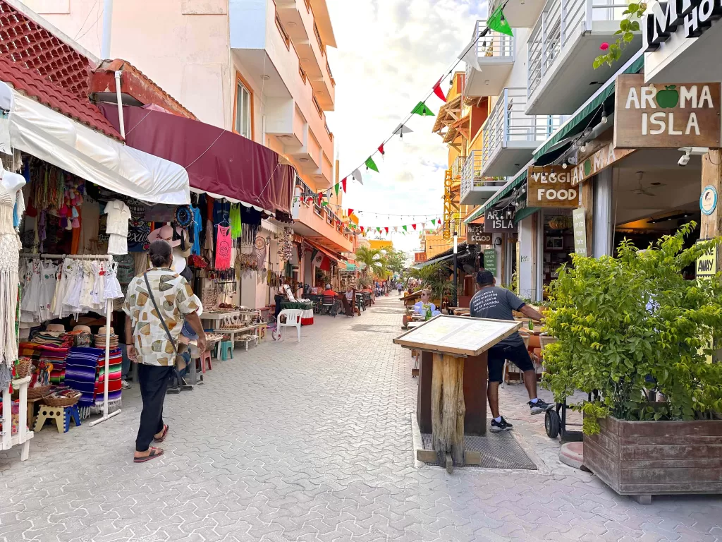 A street with shops and people walking down it