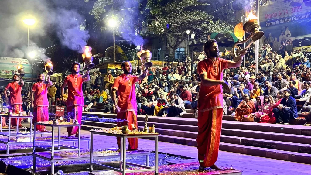 A group of men performing on stage with a crowd watching