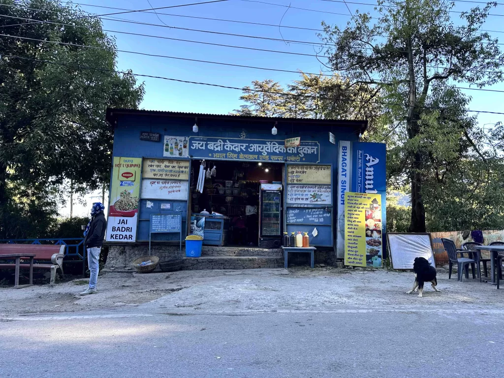 A small blue building with signs on the front