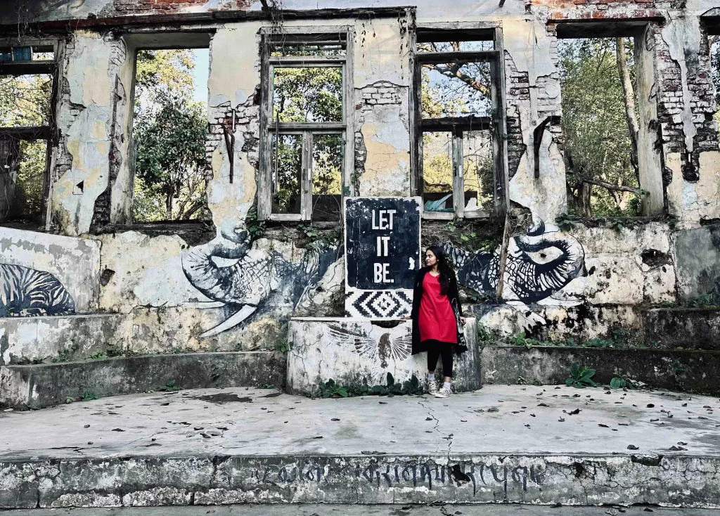 A person in front of a wall and graffiti