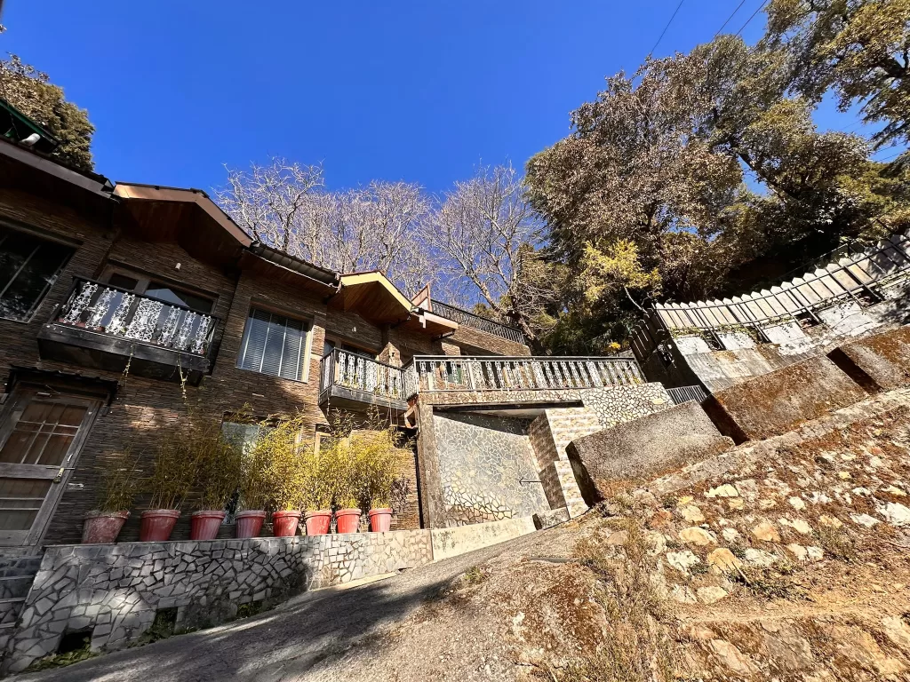 A building with trees and a stone wall