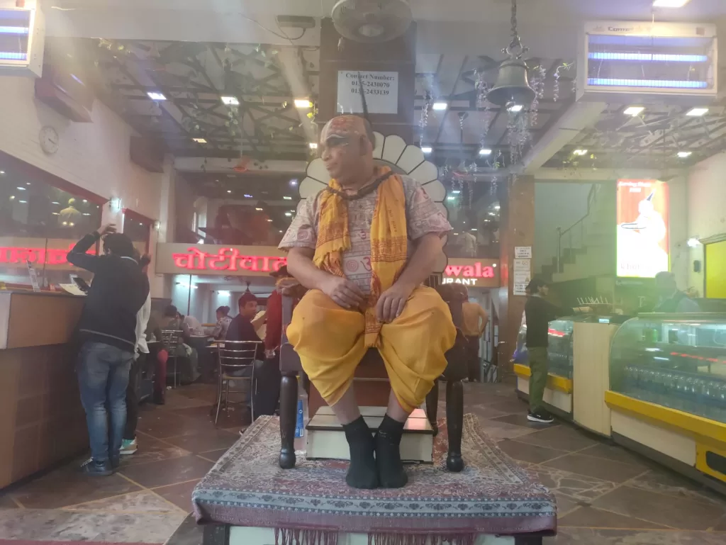 A person sitting on a platform in a mall