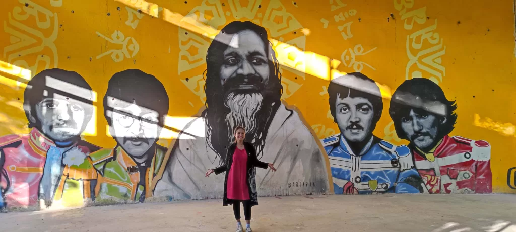 A person standing in front of a mural