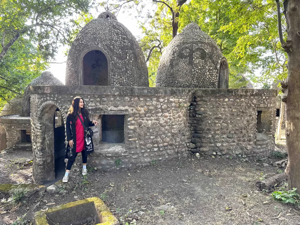 A person standing in front of a stone building