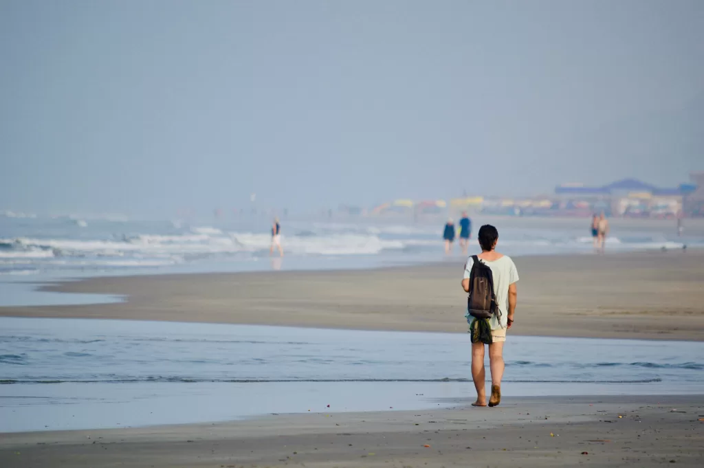 A person walking on a beach. Part of the 3 Day North Goa Itinerary