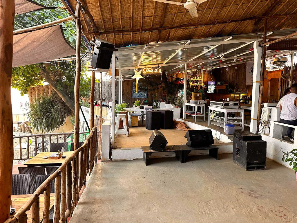 A patio with a large building and speakers. This is it one of the best places for Live events and hippie parties in Arambol