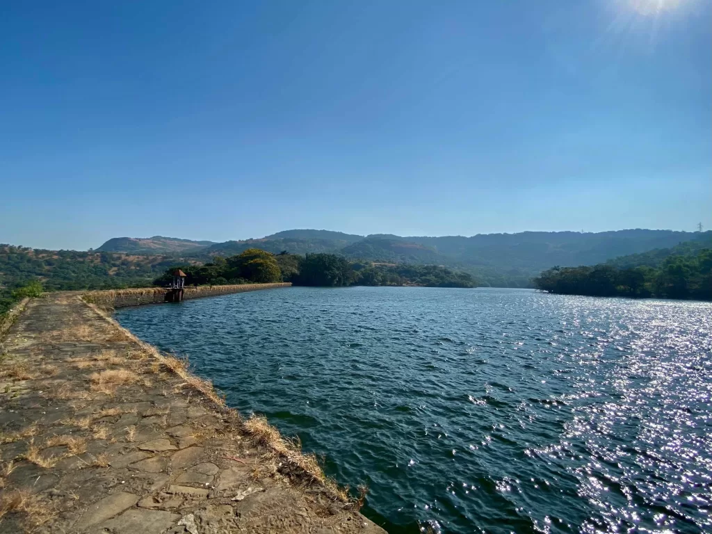 A body of water with trees in the background. Part of One-Day Itinerary of Lonavala.