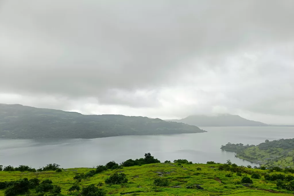 A landscape of a lake with hills and trees