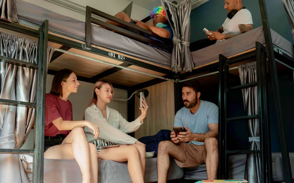 A group of people sitting on bunk beds in Hostels in Goa.