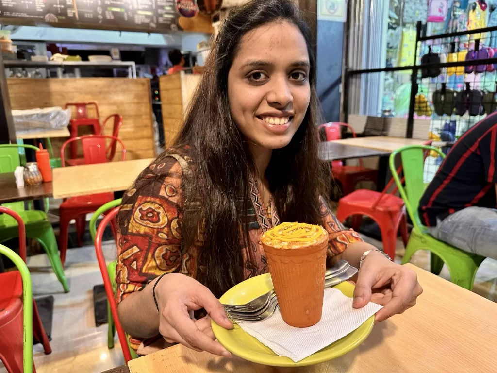 A person holding a cup. One of the best street food in Mumbai