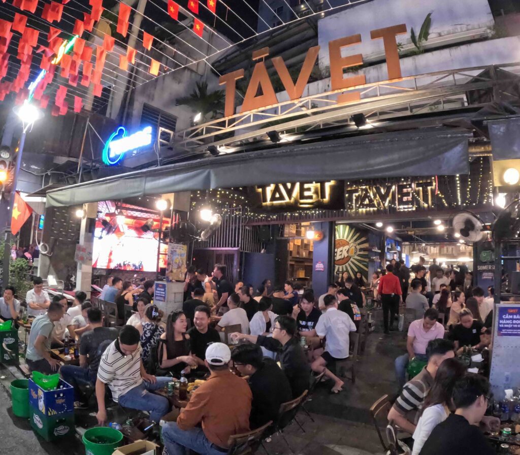 People sitting on chairs in groups.