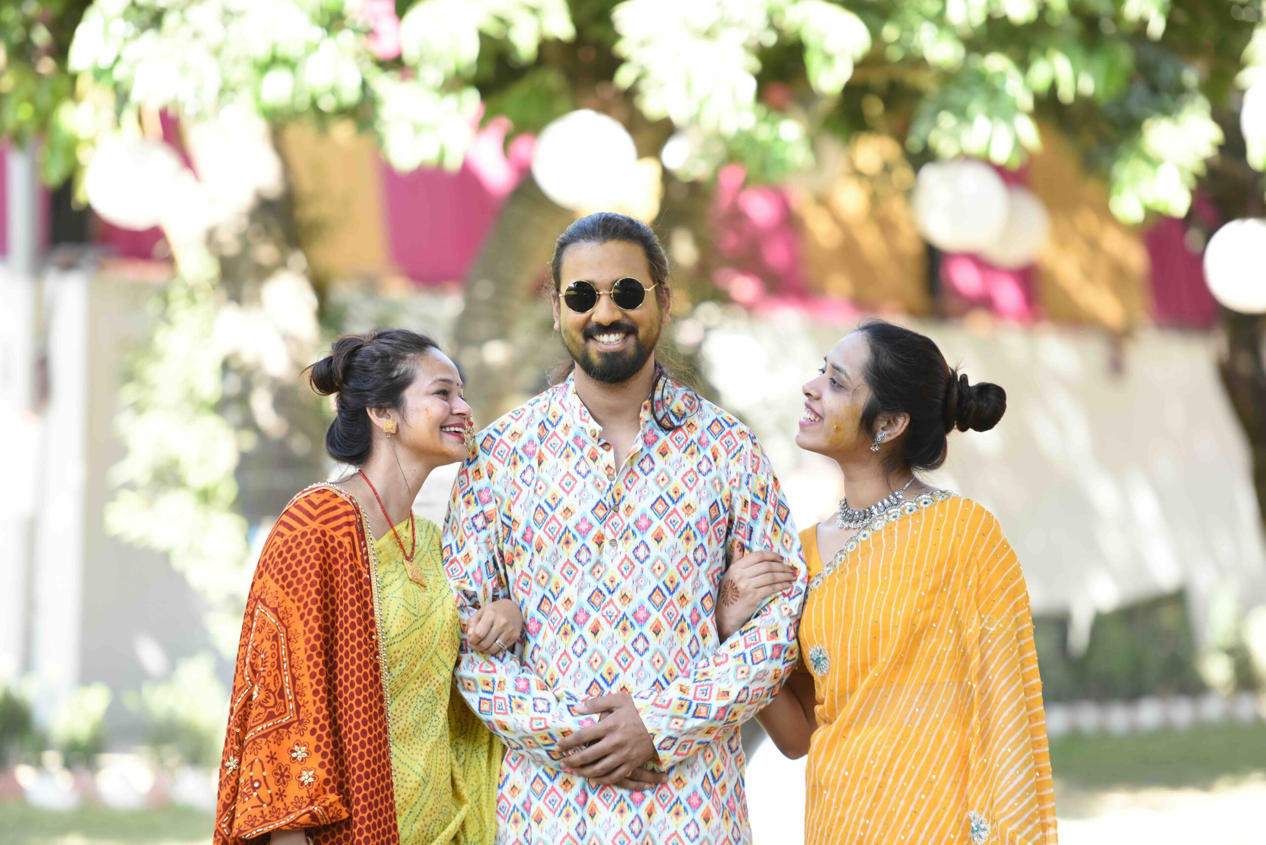 Two people looking at one person all wering colorful clothes