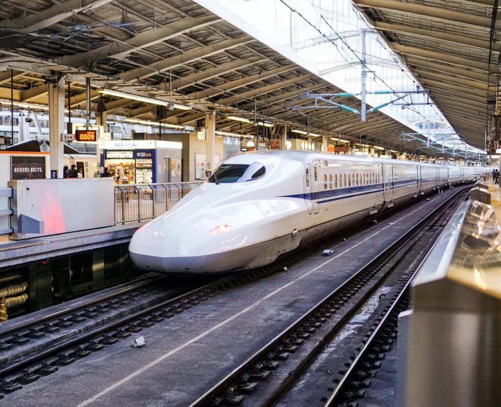 Bullet train passing through a train station in Japan