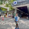 A person standing in front of VFS global office in Mumbai.