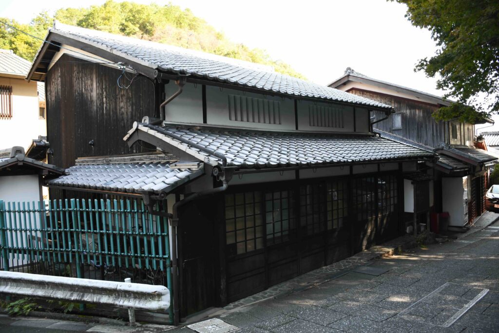 An old Japanese house with blue fence.