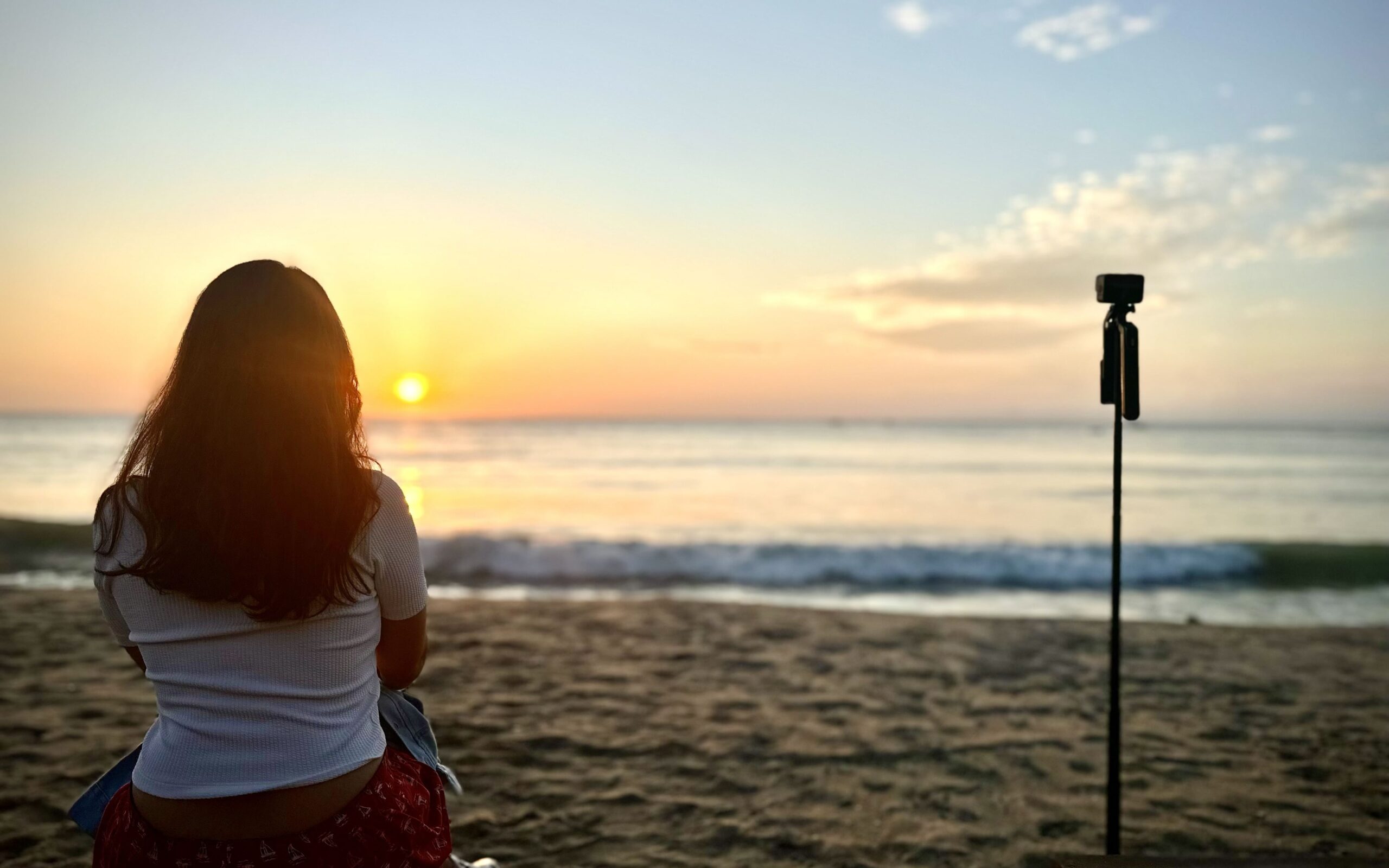 A person looking at sunrise next to the camera in Arugam Bay, Sri Lanka