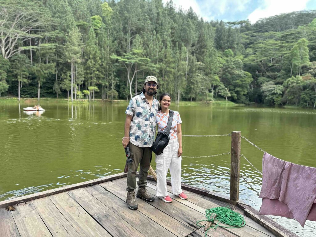 A man and a woman in front of a pond near Ambuluwawa tower Sri Lanka
