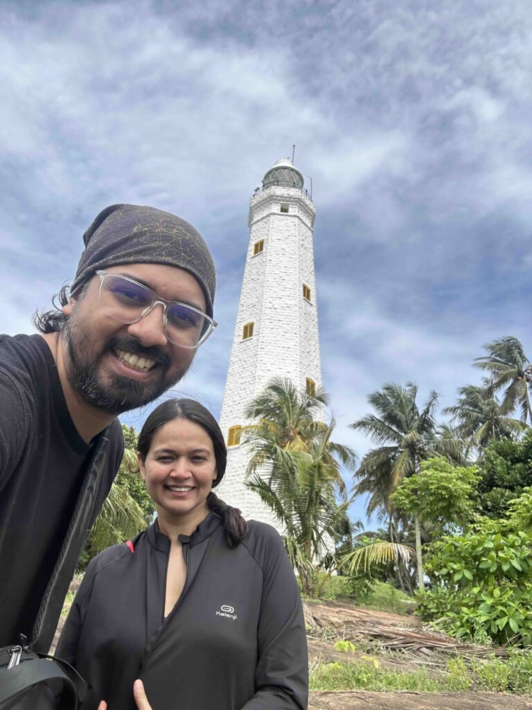 2 people in front of the Dondra lighthouse, one of the best places to see during monsoons in South Sri Lanka