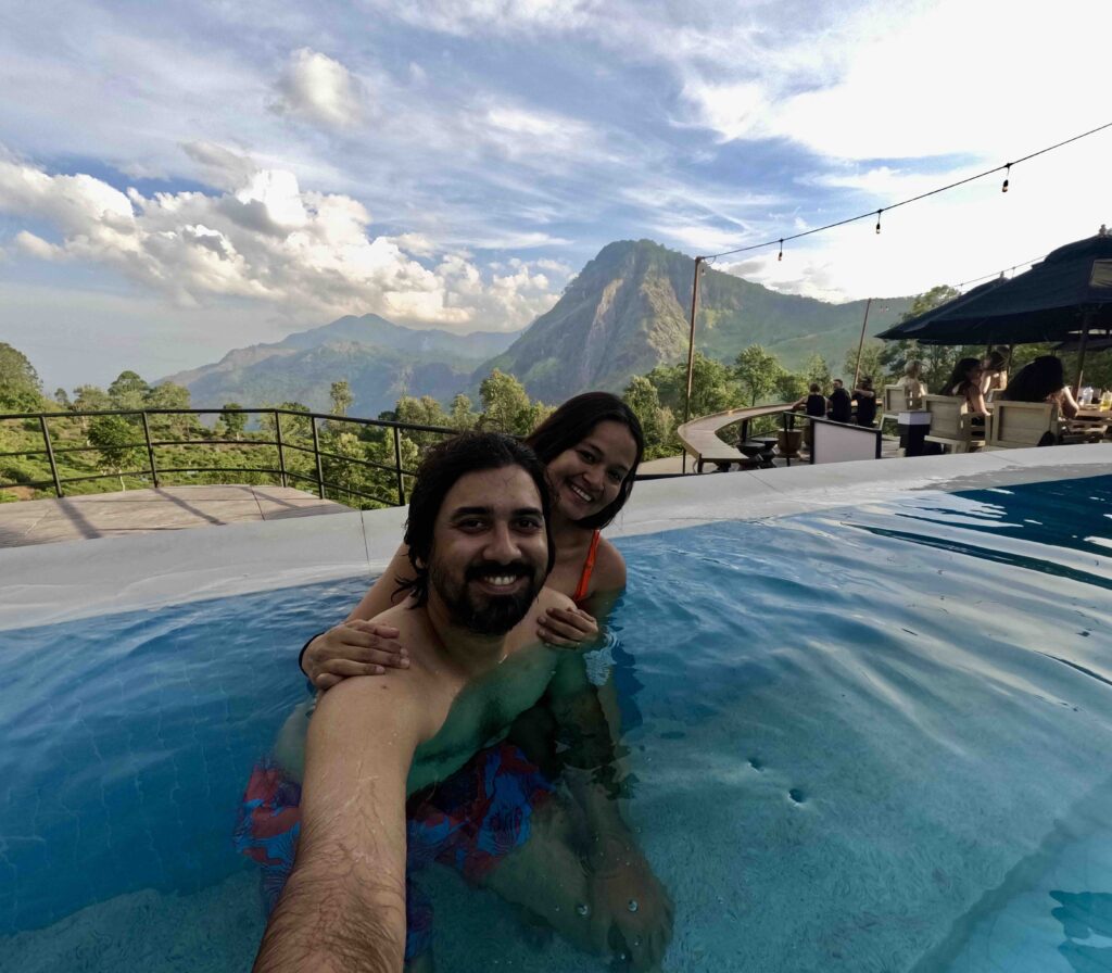 A man and a woman posing in front of the camera in side the Ravana Pool club. Your travel guide to Ella should include this fun day.